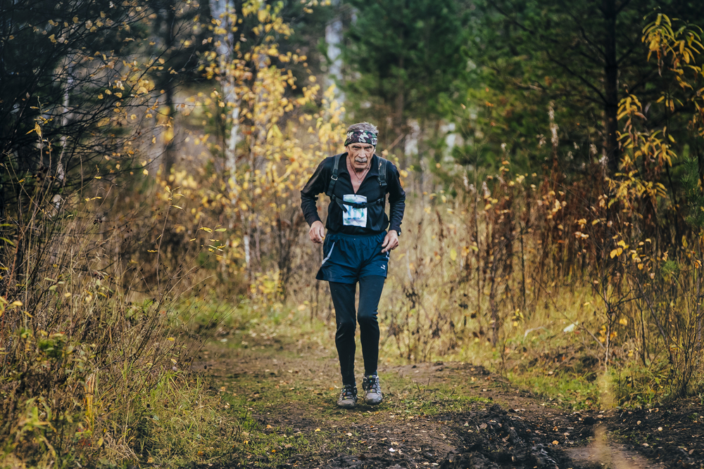 Old man running on a trail