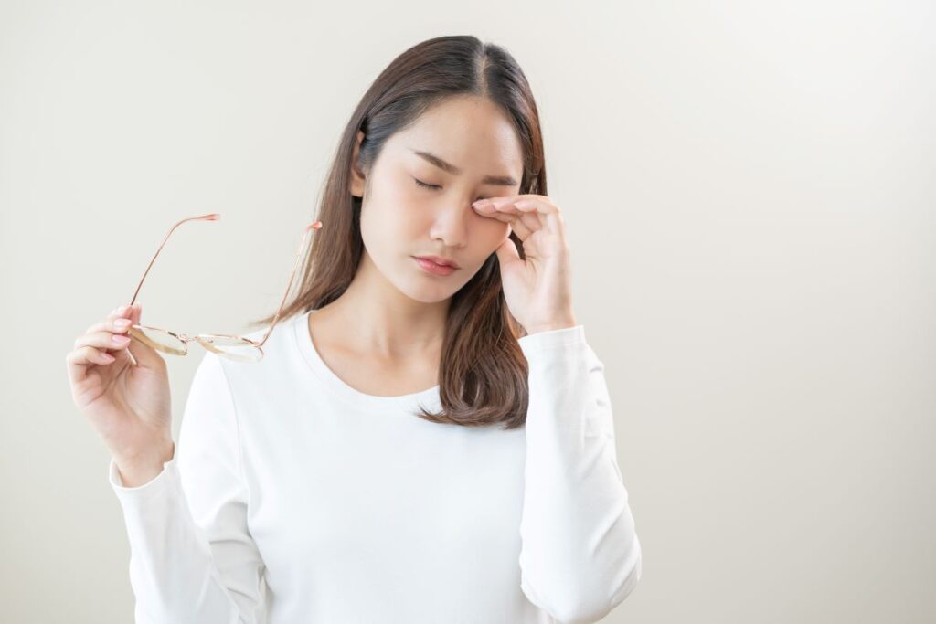 Woman scratching eye